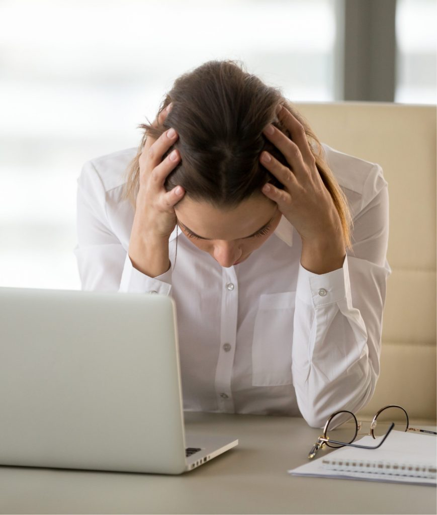 Woman with a headache at work